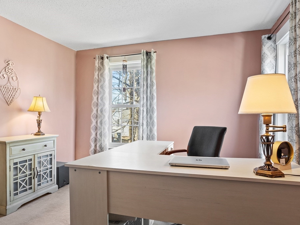 16 Main Street, Unit 3 Pepperell, MA 01463 - Photo 18 of 30 a bedroom with a bed and a lamp on the dresser