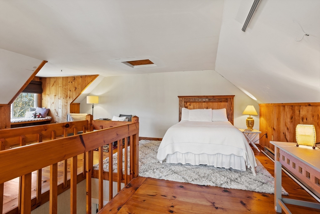 16 Main Street, Unit 3 Pepperell, MA 01463 - Photo 22 of 30 a bedroom with a bed and wooden floor