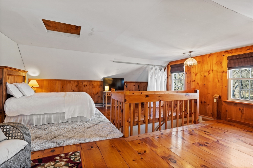 16 Main Street, Unit 3 Pepperell, MA 01463 - Photo 23 of 30 a bedroom with furniture and a wooden floor
