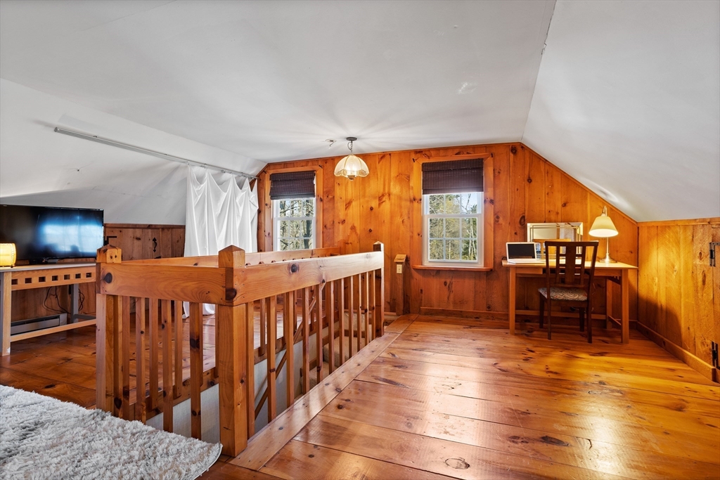 16 Main Street, Unit 3 Pepperell, MA 01463 - Photo 25 of 30 a bedroom with furniture and a flat screen tv