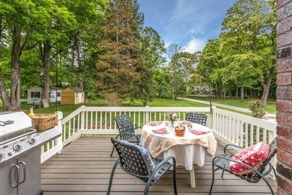 16 Main Street, Unit 3 Pepperell, MA 01463 - Photo 3 of 30 a view of a deck with furniture and trees around