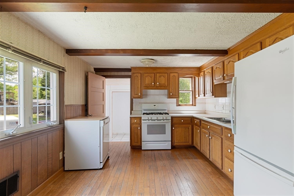 19 Butler Avenue Wakefield, MA 01880 - Photo 12 of 33 a kitchen with stainless steel appliances granite countertop a stove and a refrigerator