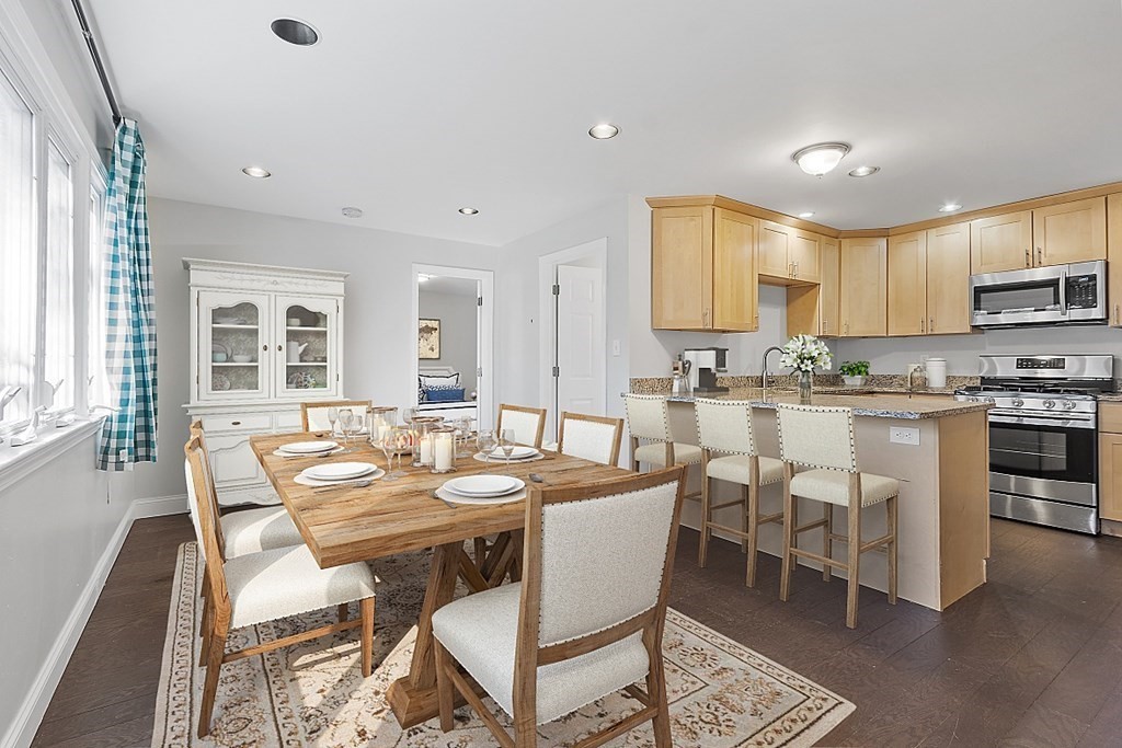 126 South Row Road Lunenburg, MA 01462 - Photo 3 of 28 a dining room with a table chairs and a kitchen view