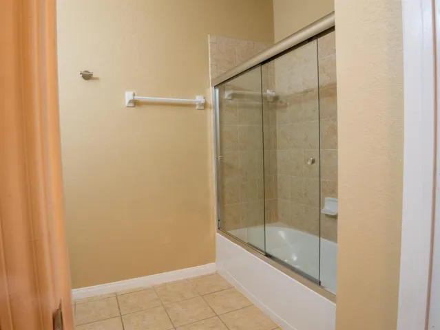 a bathroom with a glass shower door