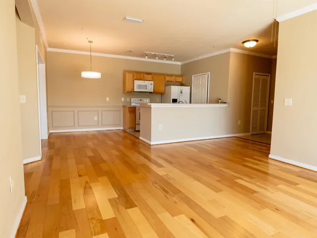 a view of a room with wooden floor
