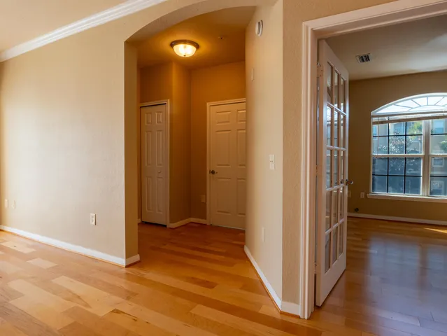 a view of a hallway with wooden floor