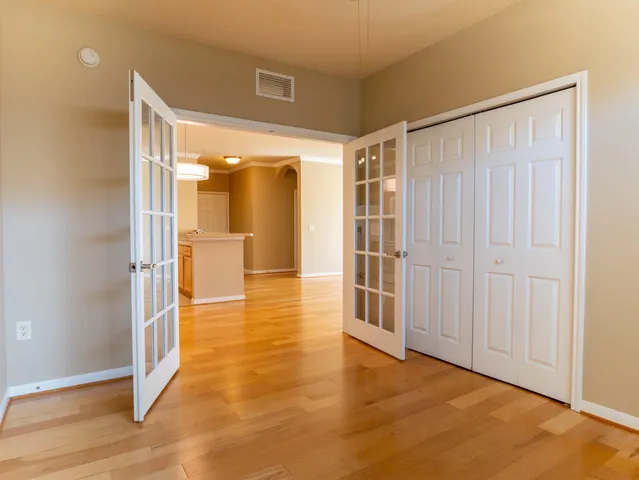 a view of a hallway with wooden shelves