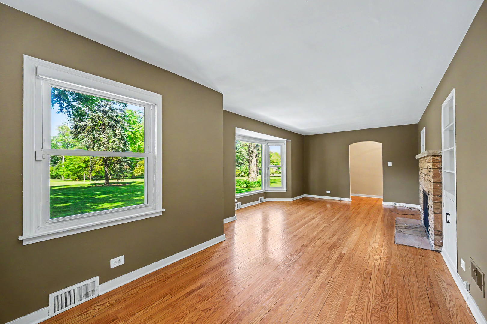 325 South Lambert Road Glen Ellyn, IL 60137 - Photo 10 of 32 a view of an empty room with wooden floor and a window