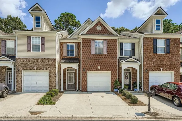 a front view of a house with parking space