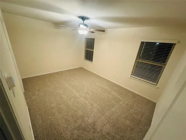 a view of an empty room with a fireplace