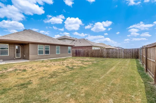 a view of an house with backyard and entertaining space