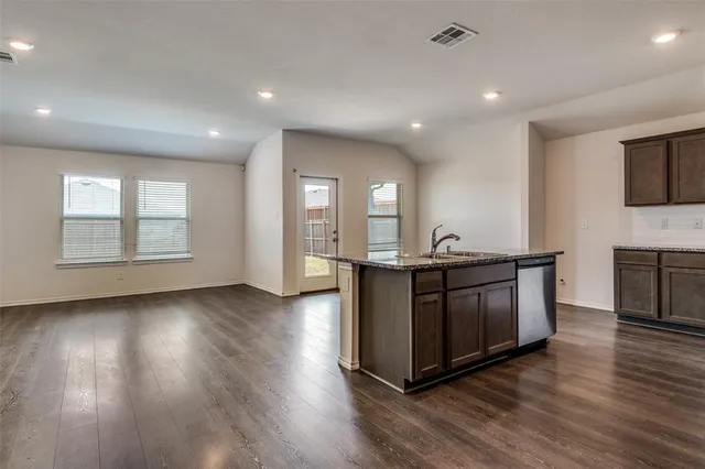 an open kitchen with sink and cabinets