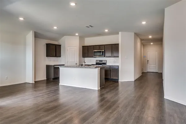 a view of kitchen with microwave a stove a sink and a refrigerator
