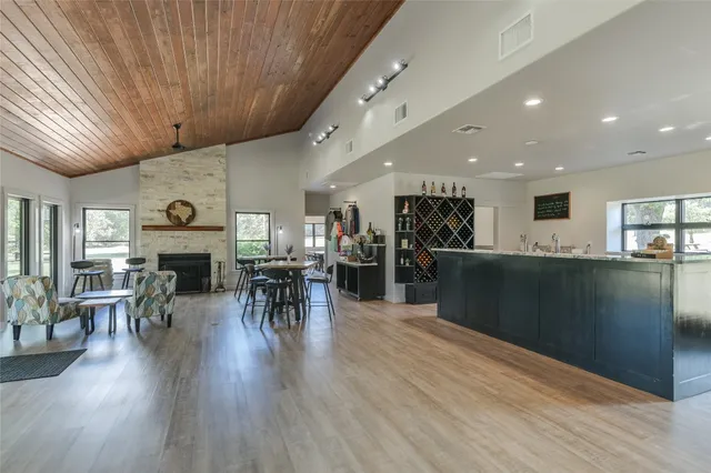 a living room with furniture a fireplace and wooden floor