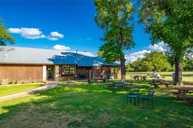 a view of a chairs and table in a yard