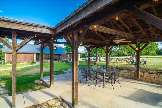 a patio with yard glass top table and chairs