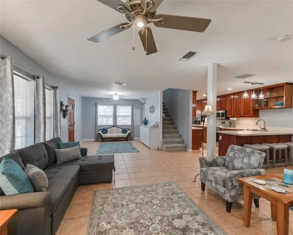 a living room with furniture and kitchen view