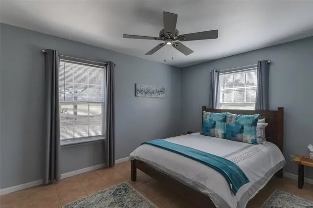 a bedroom with a large bed and a window