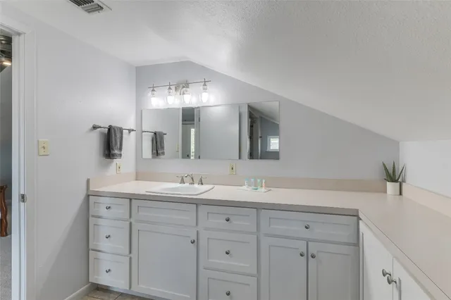 a bathroom with a double vanity sink and mirror