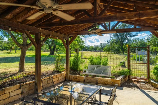 a patio with yard glass top table and chairs