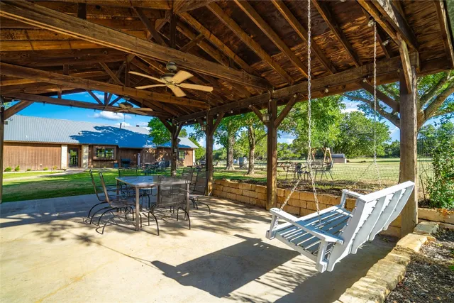 a view of a patio with a table chairs and a backyard