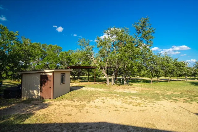 a swimming pool with a lawn chairs and wooden fence