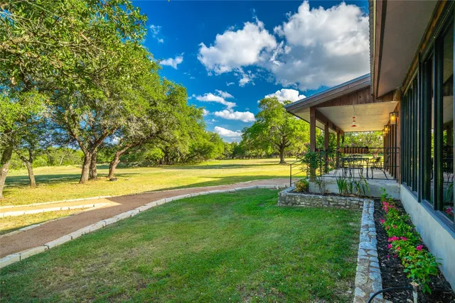 a view of a house with swimming pool and a yard