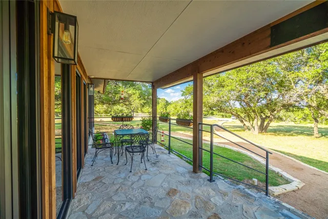 a view of a porch with chairs and backyard
