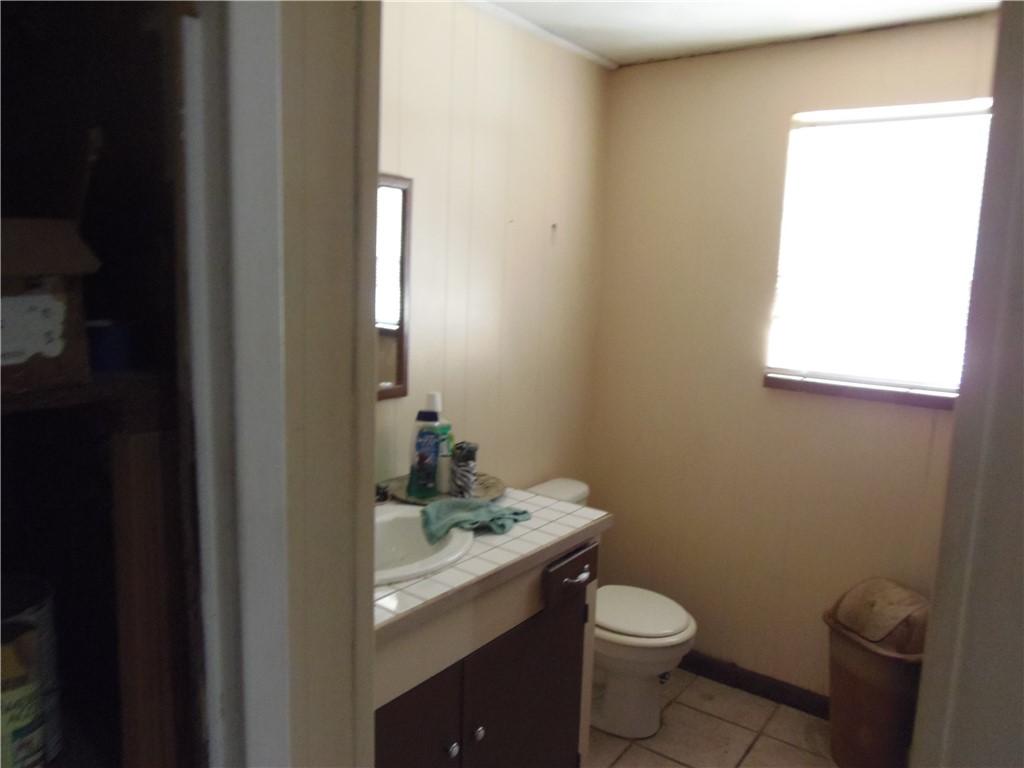 916 Marriott Drive Portland, TX 78374 - Photo 11 of 24 a white toilet sitting next to a bathroom sink