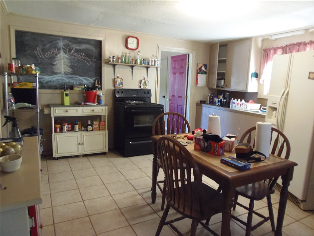 916 Marriott Drive Portland, TX 78374 - Photo 5 of 24 a kitchen with stainless steel appliances kitchen island granite countertop a table and chairs in it