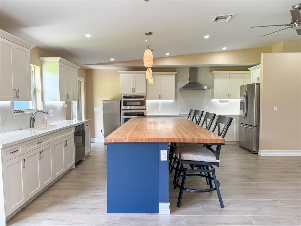 17420 Southwest 54th Street Southwest Ranches, FL 33331 - Photo 13 of 40 a large kitchen with a table and chairs