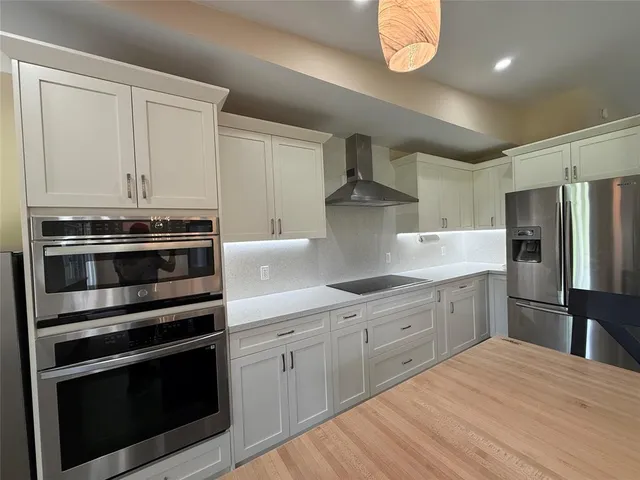 a kitchen with a stove oven and a refrigerator