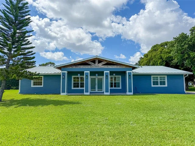 a view of a brick house with a yard