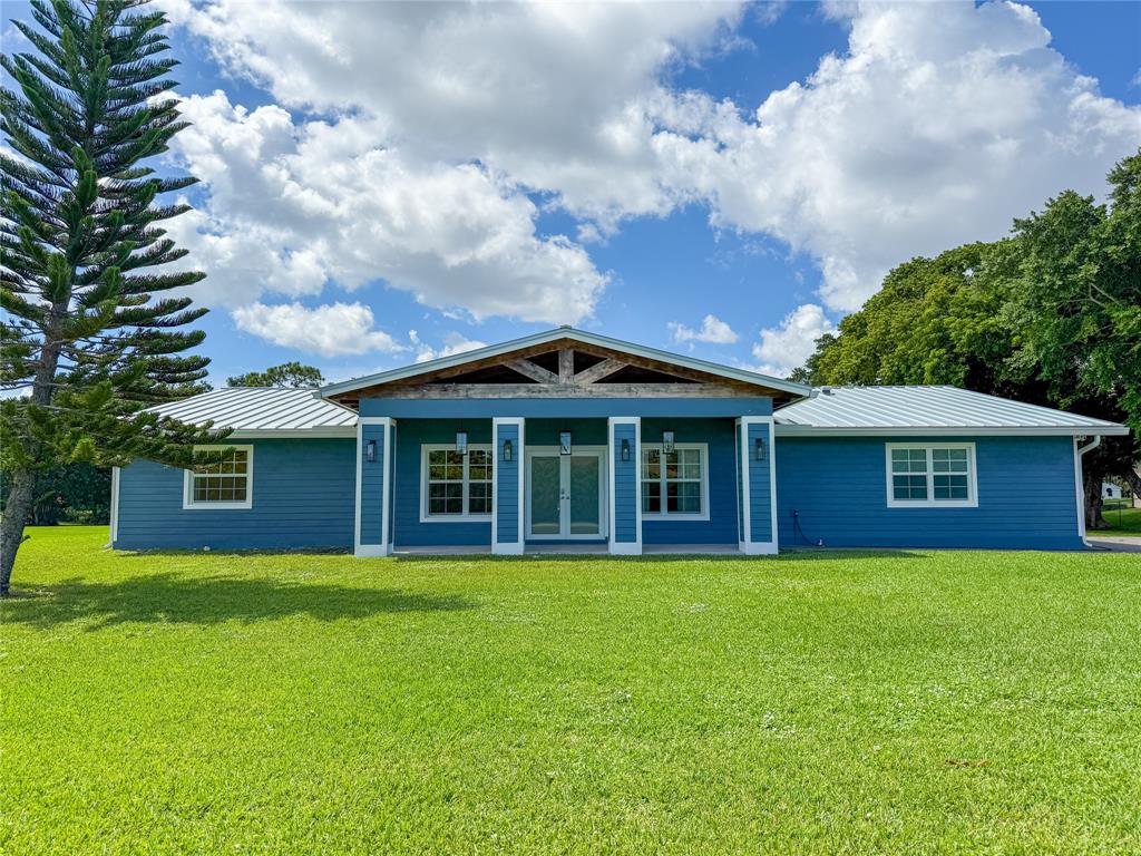 17420 Southwest 54th Street Southwest Ranches, FL 33331 - Photo 2 of 40 a view of a brick house with a yard