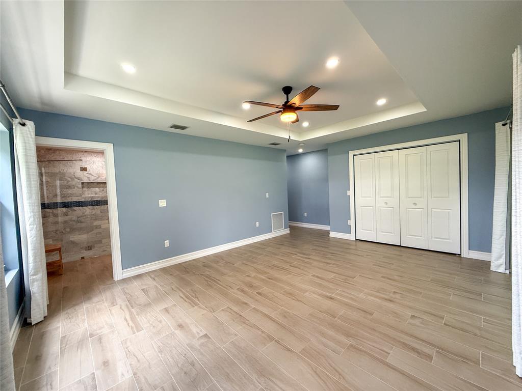 17420 Southwest 54th Street Southwest Ranches, FL 33331 - Photo 21 of 40 wooden floor in an empty room with a window