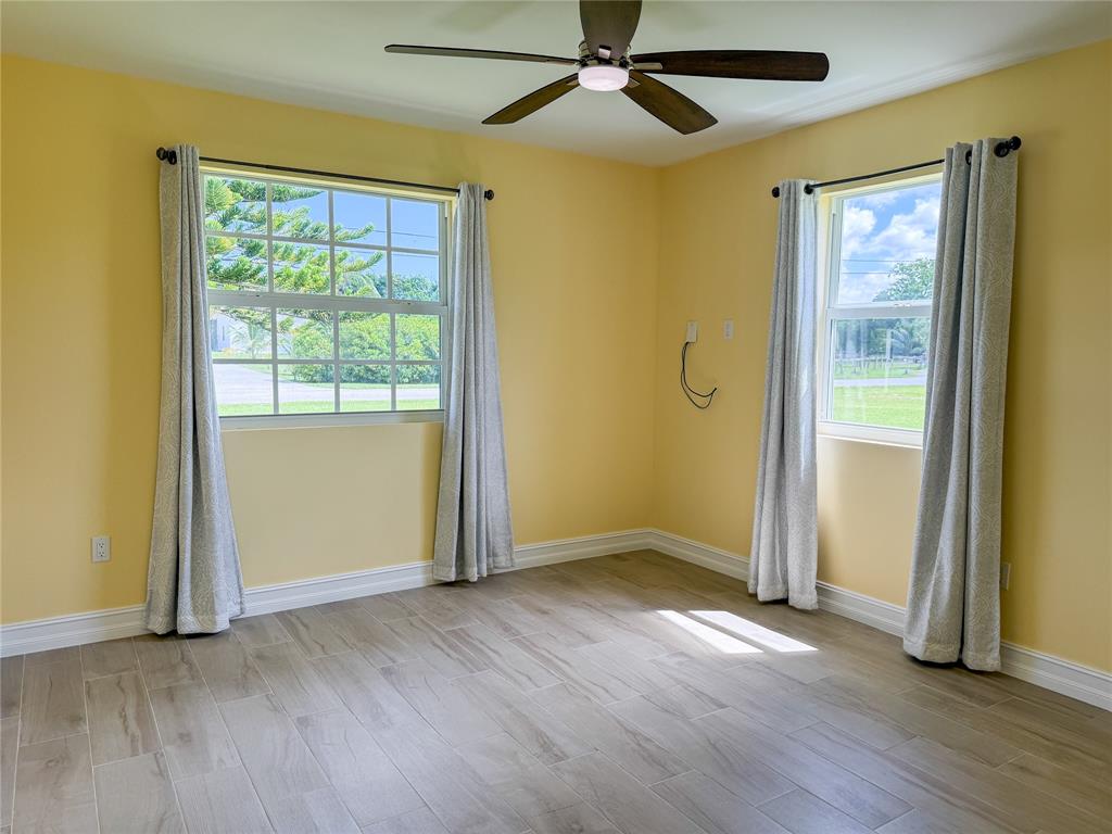 17420 Southwest 54th Street Southwest Ranches, FL 33331 - Photo 25 of 34 an empty room with wooden floor closet and windows
