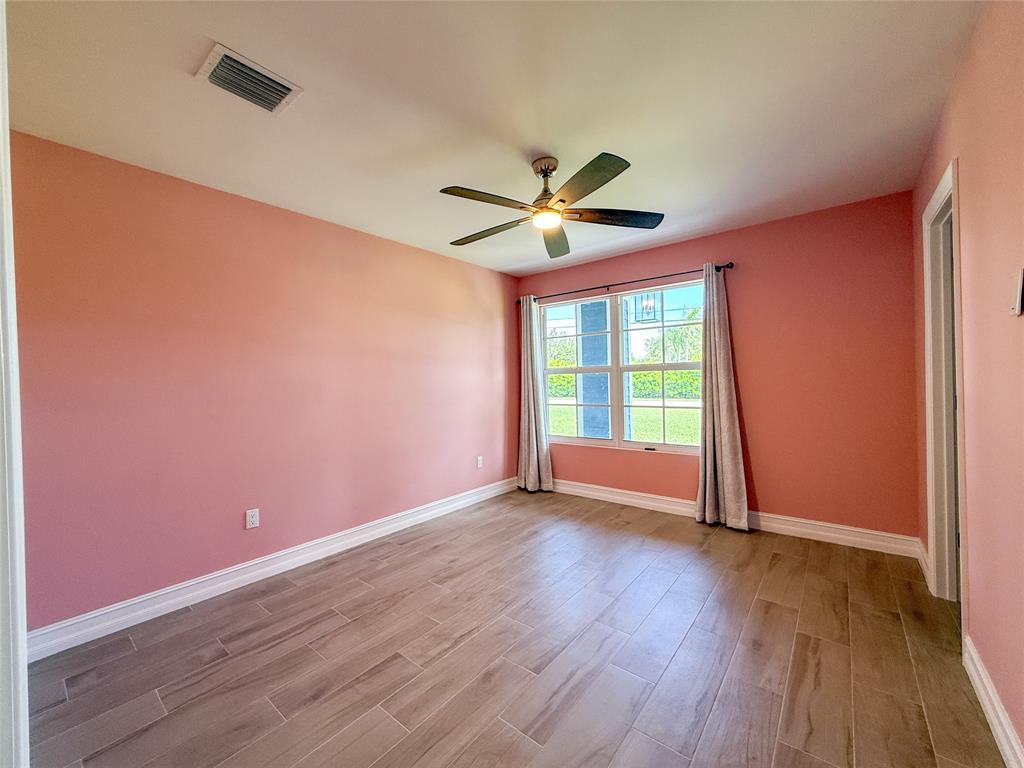 17420 Southwest 54th Street Southwest Ranches, FL 33331 - Photo 30 of 34 an empty room with wooden floor and windows