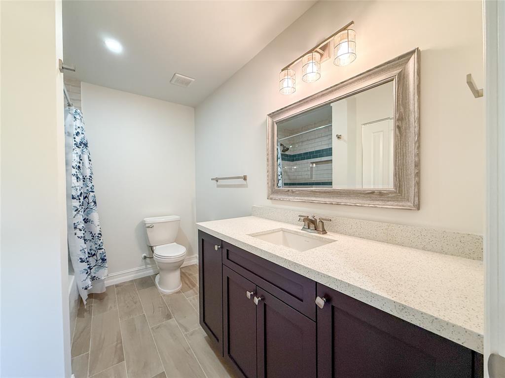 17420 Southwest 54th Street Southwest Ranches, FL 33331 - Photo 31 of 40 a bathroom with a sink a toilet and a mirror