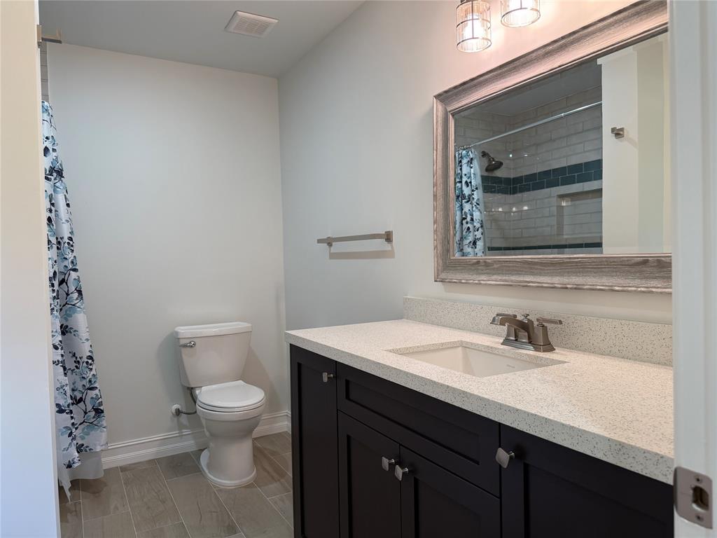 17420 Southwest 54th Street Southwest Ranches, FL 33331 - Photo 32 of 40 a bathroom with a toilet a sink and a mirror