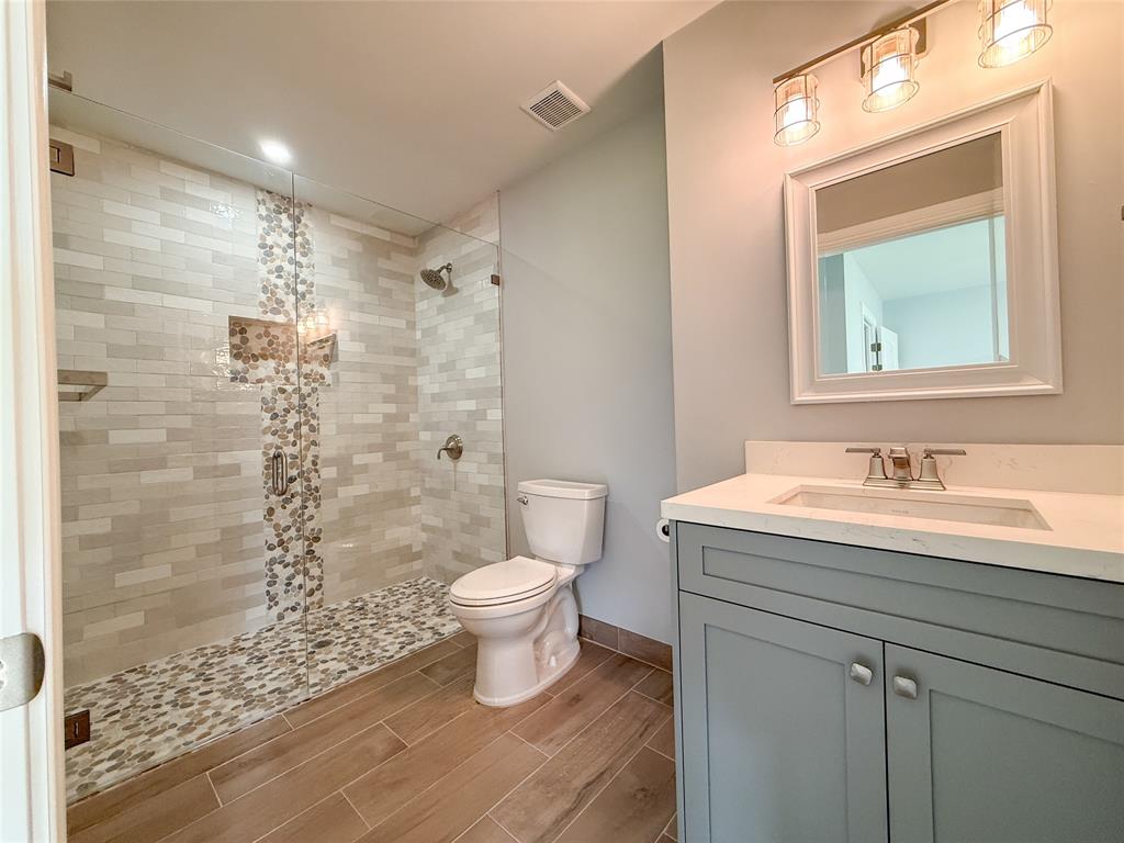 17420 Southwest 54th Street Southwest Ranches, FL 33331 - Photo 37 of 40 a bathroom with a granite countertop sink toilet a mirror and shower