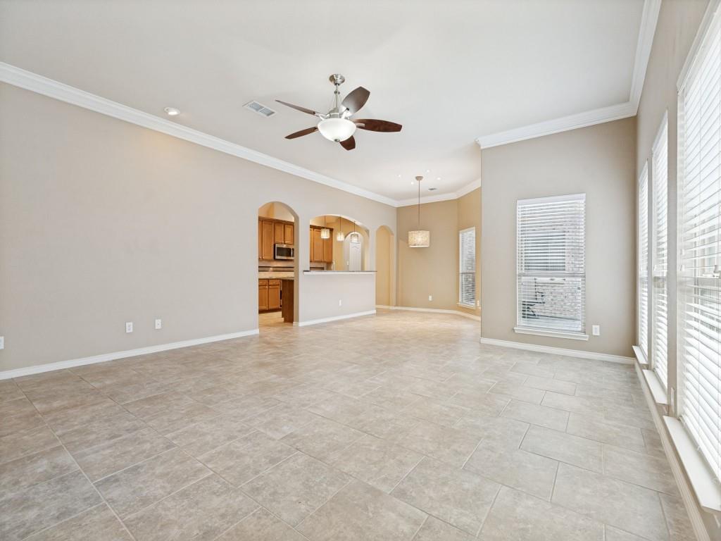 10032 Bell Rock Road Frisco, TX 75035 - Photo 7 of 23 Spacious room with neutral tile flooring and crown molding.