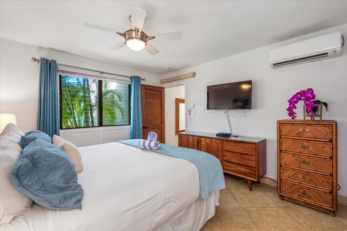 5271 Lower Honoapiilani Road, Unit B44 Lahaina, HI 96761 - Photo 12 of 25 a bedroom with a bed and a flat tv screen on dresser