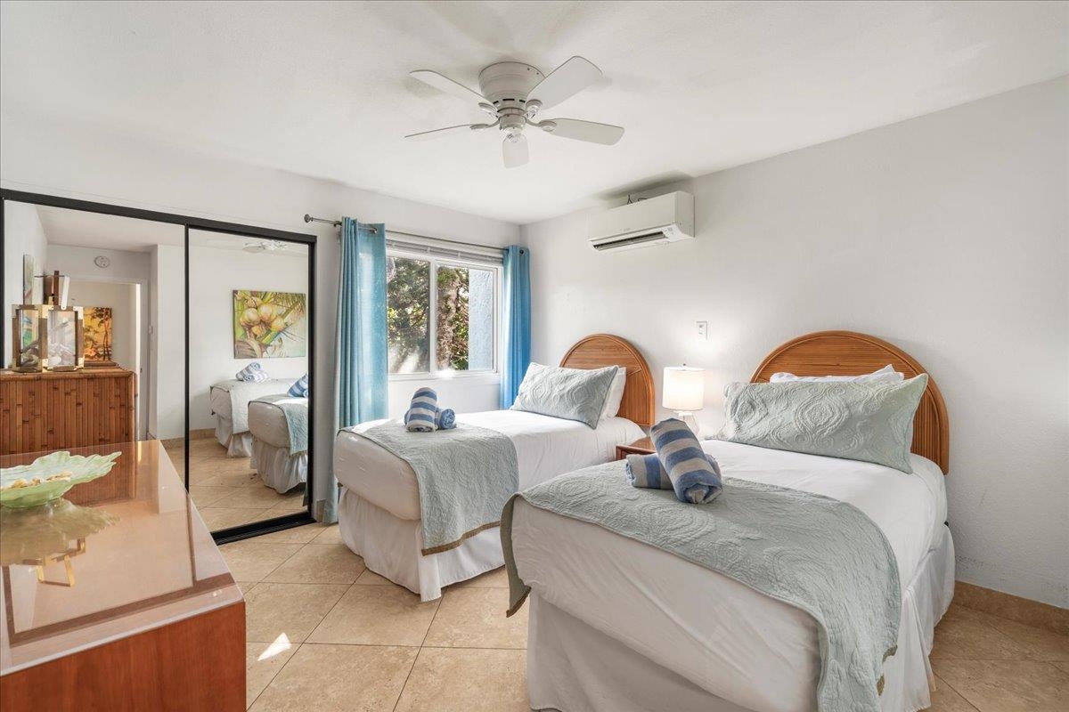 5271 Lower Honoapiilani Road, Unit B44 Lahaina, HI 96761 - Photo 14 of 25 a bedroom with bed and a chandelier