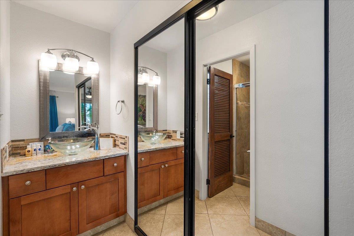 5271 Lower Honoapiilani Road, Unit B44 Lahaina, HI 96761 - Photo 16 of 25 a bathroom with a double vanity sink and a mirror