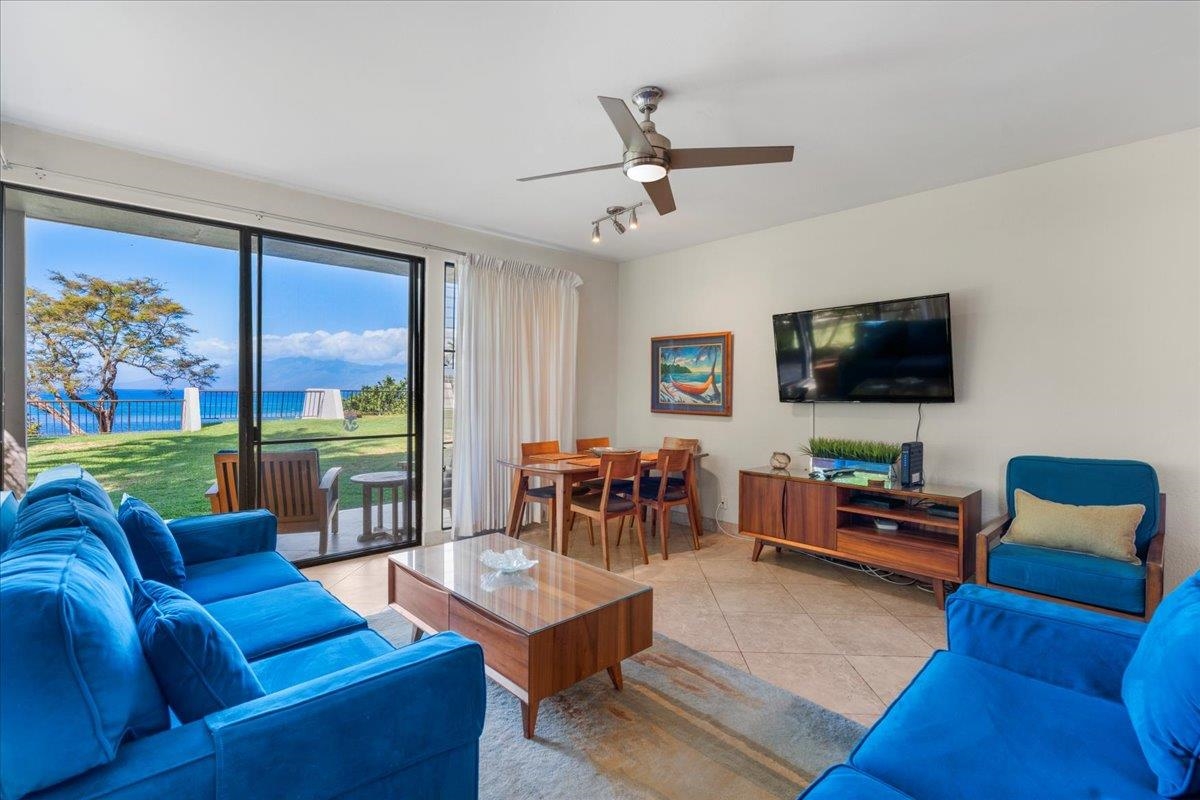5271 Lower Honoapiilani Road, Unit B44 Lahaina, HI 96761 - Photo 3 of 25 a living room with furniture and a flat screen tv