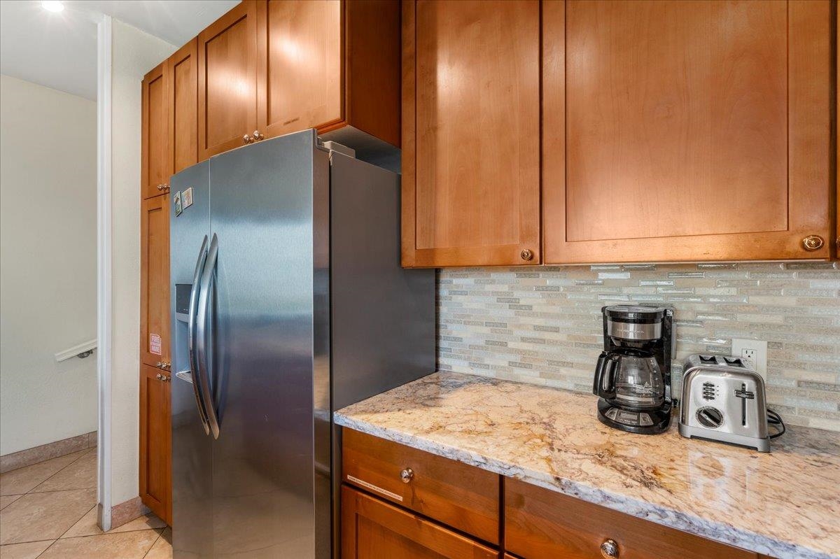 5271 Lower Honoapiilani Road, Unit B44 Lahaina, HI 96761 - Photo 6 of 25 a kitchen with stainless steel appliances granite countertop a sink a refrigerator and cabinets