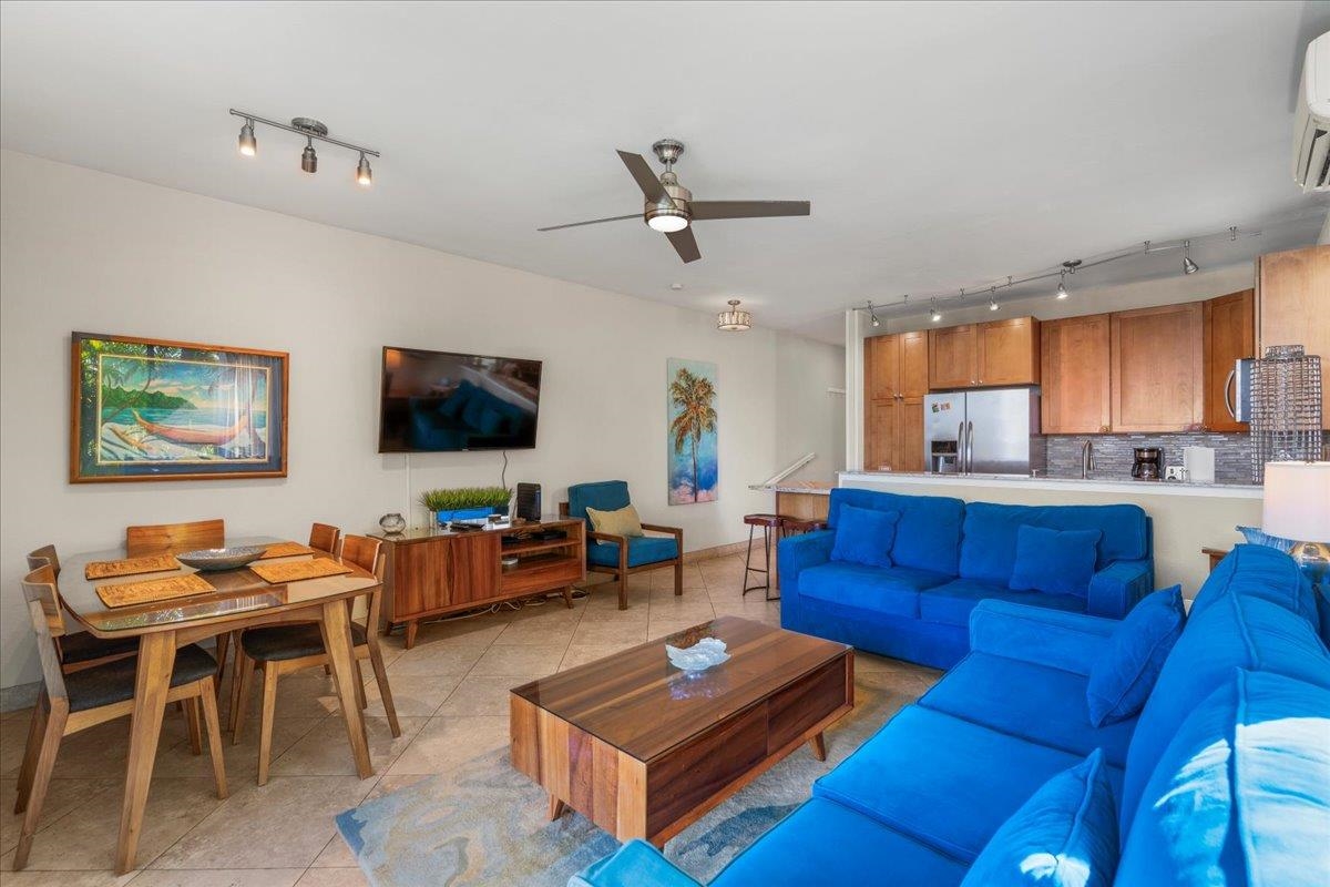 5271 Lower Honoapiilani Road, Unit B44 Lahaina, HI 96761 - Photo 9 of 25 a living room with furniture a flat screen tv and kitchen view