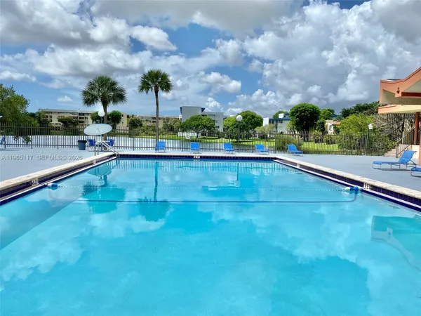a view of a swimming pool and a yard