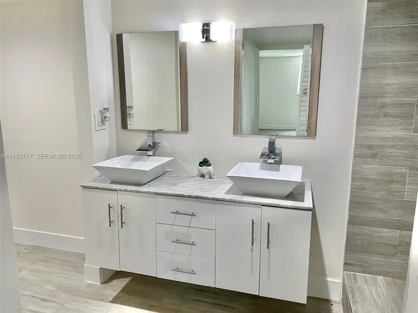 a bathroom with a double vanity sink and a mirror