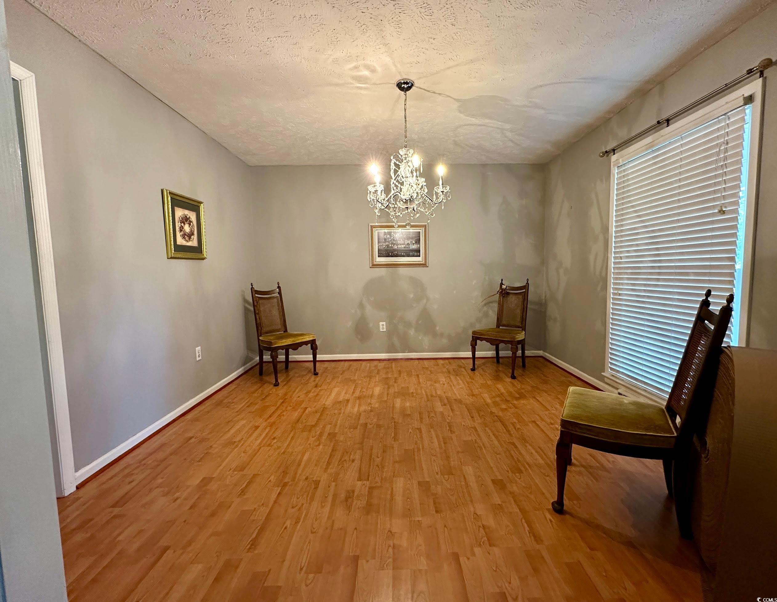 601 Jefferson Street Bennettsville, SC 29512 - Photo 12 of 20 Sitting room with a chandelier, a textured ceiling, and light wood-style floors